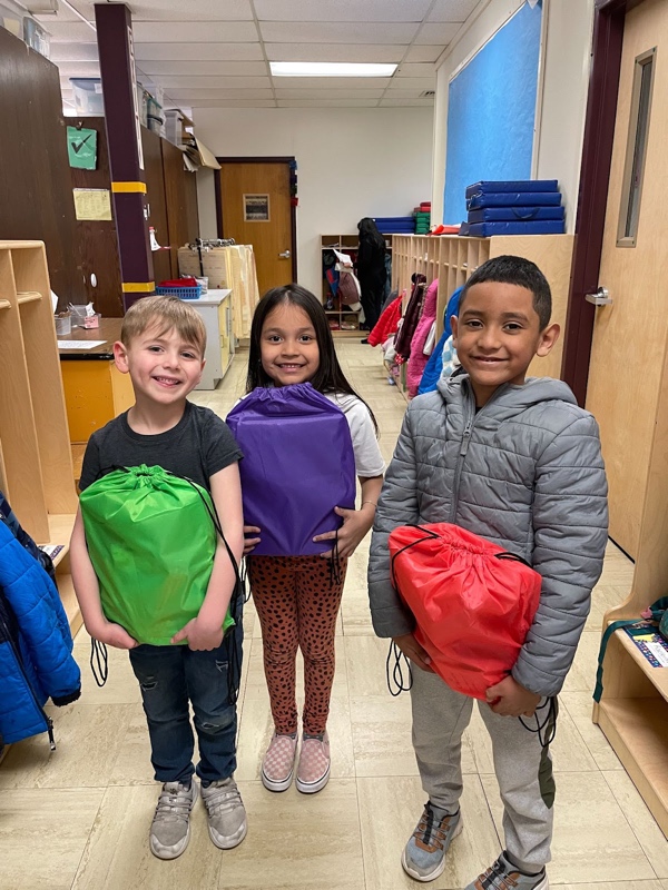 Children holding backpacks